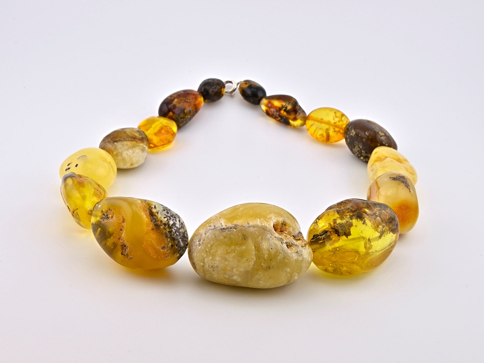 Big Ball Rack Amber Necklace is handmade from Natural Baltic Amber  Color: Milky-Yellow, Clear-Yellow-Cognac with natural Ingrowth and Mosaic, half Mat and half Transparent  Clasp: Sterling Silver Lobster Claw&nbsp;  Weight: 142g / 5oz