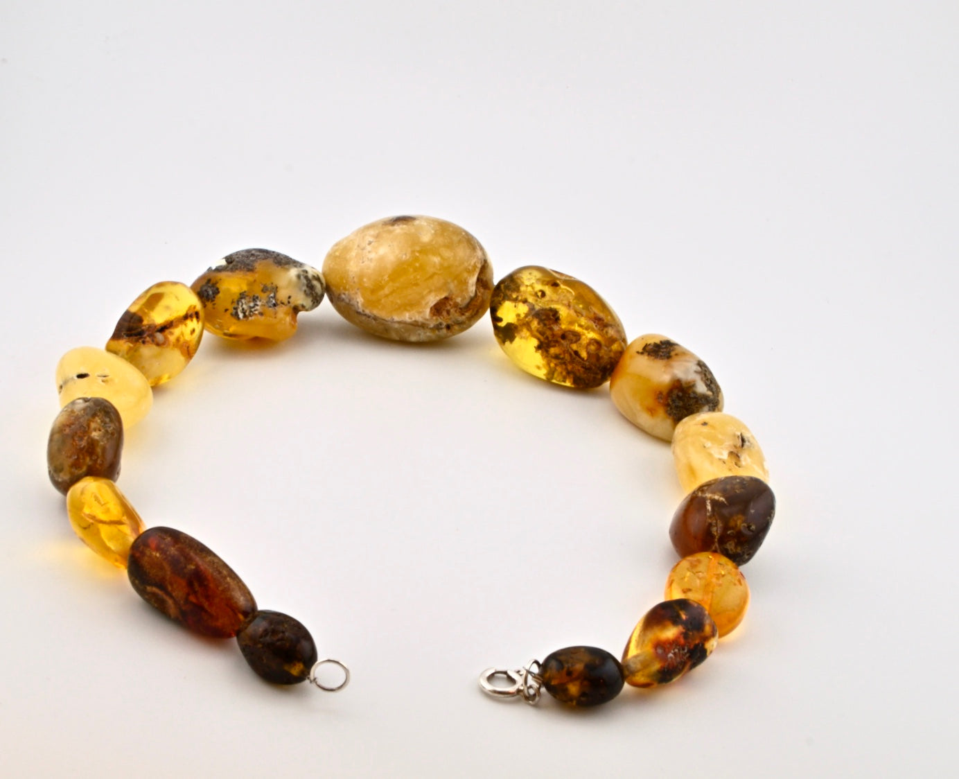 Big Ball Rack Amber Necklace is handmade from Natural Baltic Amber  Color: Milky-Yellow, Clear-Yellow-Cognac with natural Ingrowth and Mosaic, half Mat and half Transparent  Clasp: Sterling Silver Lobster Claw&nbsp;  Weight: 142g / 5oz