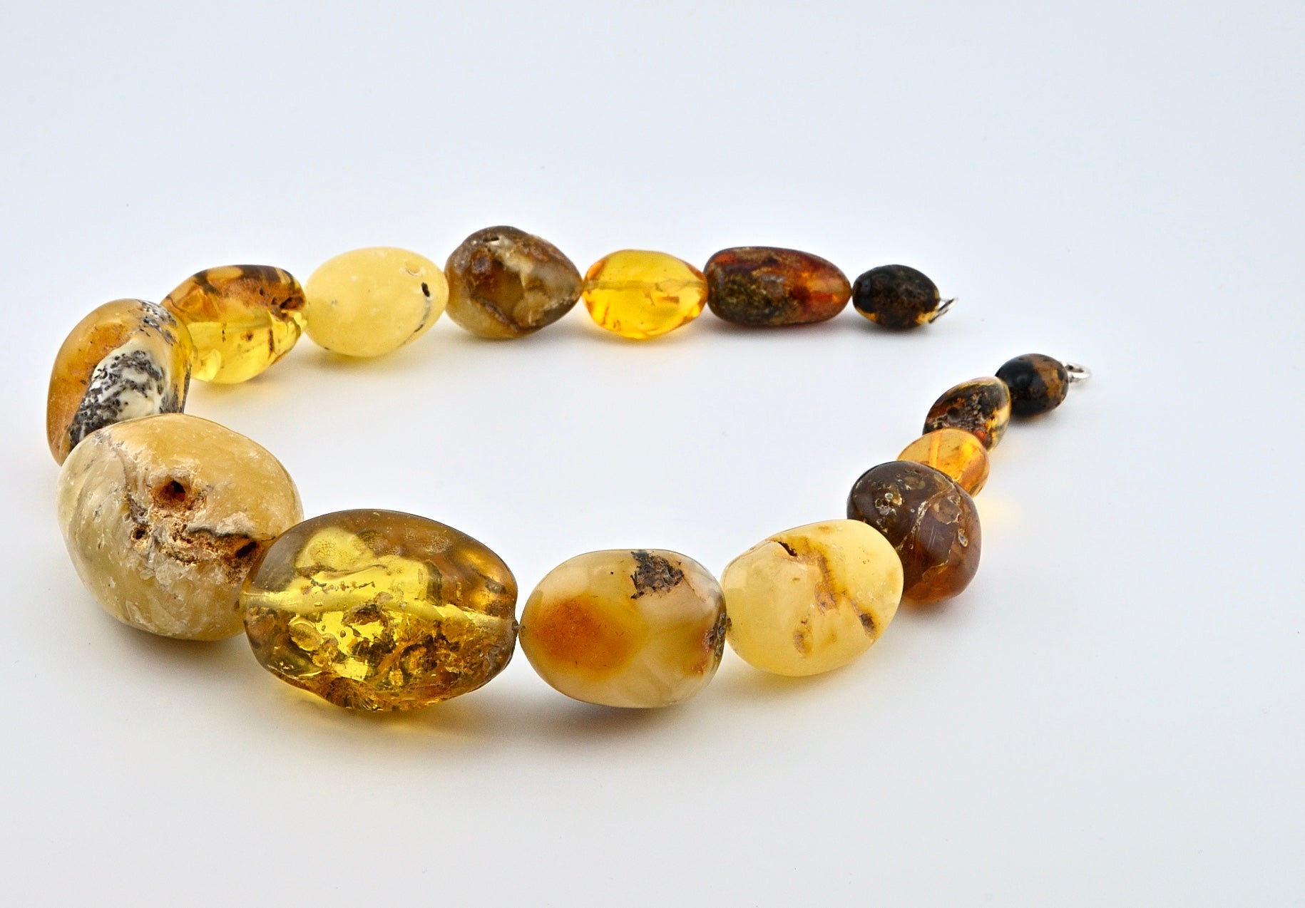 Big Ball Rack Amber Necklace is handmade from Natural Baltic Amber  Color: Milky-Yellow, Clear-Yellow-Cognac with natural Ingrowth and Mosaic, half Mat and half Transparent  Clasp: Sterling Silver Lobster Claw&nbsp;  Weight: 142g / 5oz